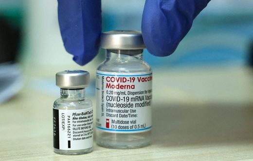 Vials of the Moderna and Pfizer COVID vaccines are seen above in Israel.
