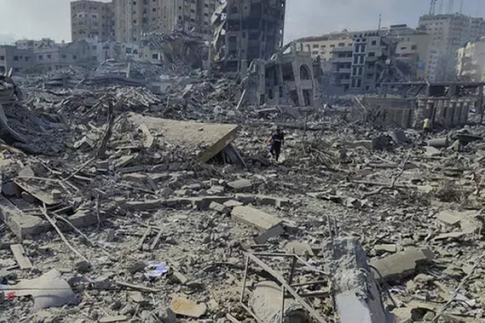 Des Palestiniens marchent dans les décombres des bâtiments détruits par les frappes aériennes israéliennes dans la ville de Gaza, mardi 10 octobre AP Hassan Eslaiah