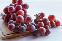 fruits-de-raisin-rouge-frais-sur-fond-de-bois-gratuit-photo