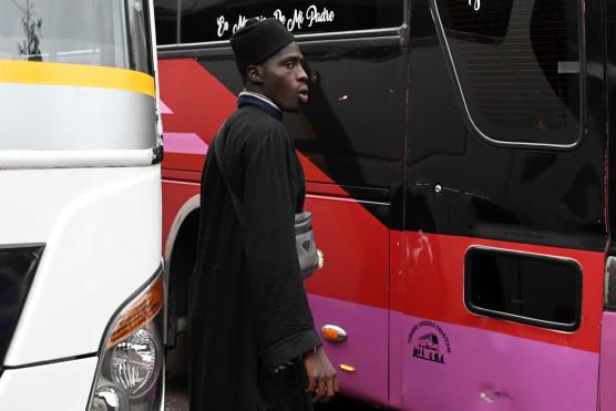 Un migrant sénégalais devant un bus qui l’emmènera à la frontière avec le Guatemala et continuera sa route vers les Etats-Unis A Tegucigalpa (Honduras), le 24 août 2023 ORLANDO SIERRA AFP