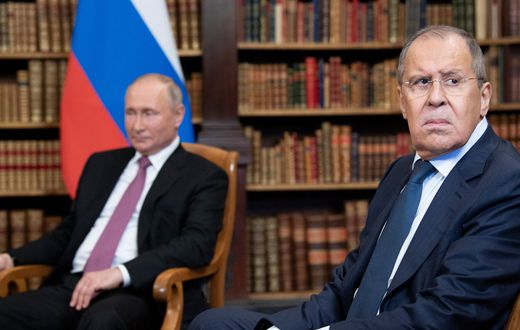 Russian Foreign Minister Sergei Lavrov looks on, next to Russian President Vladimir Putin, as they wait for the US-Russia summit at the Villa La Grange, in Geneva on June 16, 2021.