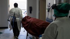 Medical staff push a stretcher with a deceased patient out of the COVID-19 intensive care unit at the United Memorial Medical Center on June 30, 2020 in Houston, Texas.