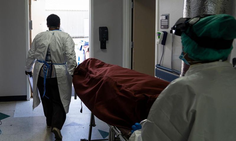 Medical staff push a stretcher with a deceased patient out of the COVID-19 intensive care unit at the United Memorial Medical Center on June 30, 2020 in Houston, Texas.