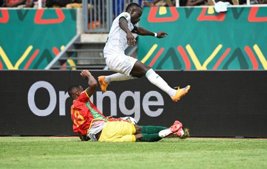 Senegal captain and forward Sadio Mane (R) evades a tackle by Guinea defender Issiaga Sylla during an Africa Cup of Nations Group B match in Bafoussam on Friday.