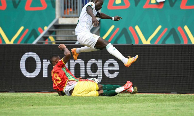 Senegal captain and forward Sadio Mane (R) evades a tackle by Guinea defender Issiaga Sylla during an Africa Cup of Nations Group B match in Bafoussam on Friday.