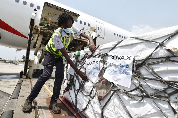 Workers unload a shipment of Covid-19 vaccines secured through COVAX in the Ivory Coast in February 2021.