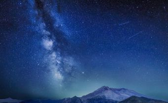 The Delta Aquariids meteor shower and Milky Way over Mount St. Helens, at Windy Ridge in Washington State with Mt. Hood, Oregon visible in the lower left corner. In 2023, it's occurring at the same time as the Alpha Capricornids shower.Diana Robinson P...