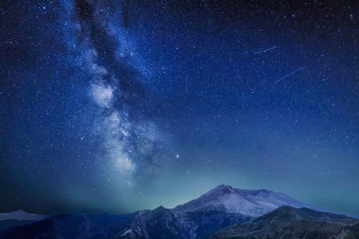 The Delta Aquariids meteor shower and Milky Way over Mount St. Helens, at Windy Ridge in Washington State with Mt. Hood, Oregon visible in the lower left corner. In 2023, it's occurring at the same time as the Alpha Capricornids shower.Diana Robinson P...