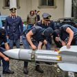 This handout picture released by the Italian police (Polizia di Stato) of Turin, on July 15, 2019, shows italian policemen carry an air-to-air missile, as part of a big cache of guns and ammunition that was seized by the Turin special police force, cal...