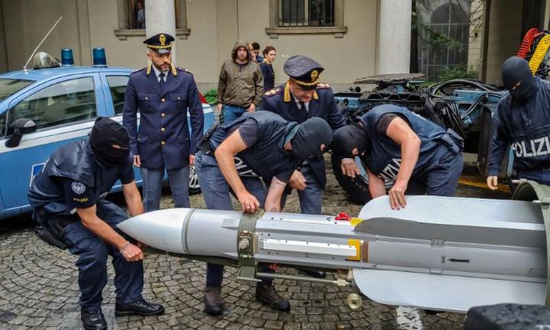 This handout picture released by the Italian police (Polizia di Stato) of Turin, on July 15, 2019, shows italian policemen carry an air-to-air missile, as part of a big cache of guns and ammunition that was seized by the Turin special police force, cal...