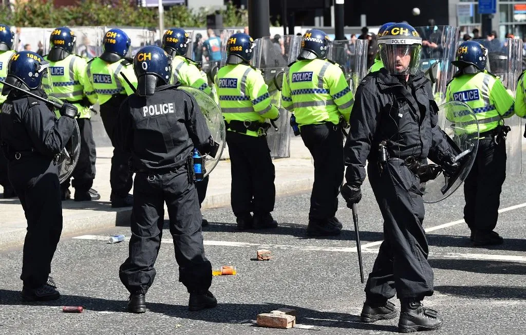 1444x920 police-officers-stand-guard-as-they-face-protesters-throwing-bricks-and-beverage-cans-outside-the-liver-building-in-liverpool-on-august-3-2024-during-the-enough-is-enough-demonstration-held-in-reacti