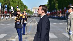 French President Emmanuel Macron stands at attention during the Bastille Day parade in Paris, July 14, 2017.