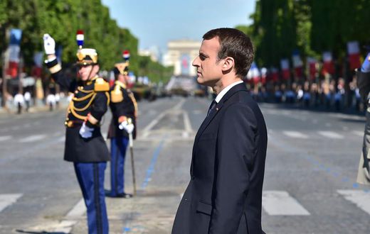 French President Emmanuel Macron stands at attention during the Bastille Day parade in Paris, July 14, 2017.