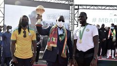 Senegal President Macky Sall holds the Africa Cup of Nations trophy flanked by coach Cisse and skipper  Kalidou Koubaly