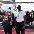 Senegal President Macky Sall holds the Africa Cup of Nations trophy flanked by coach Cisse and skipper  Kalidou Koubaly