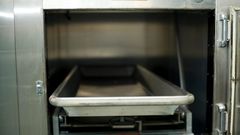 Open hospital morgue drawers used for the storage of human bodies awaiting identification or autopsy.