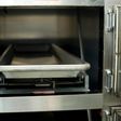 Open hospital morgue drawers used for the storage of human bodies awaiting identification or autopsy.