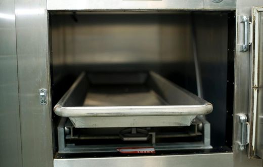 Open hospital morgue drawers used for the storage of human bodies awaiting identification or autopsy.