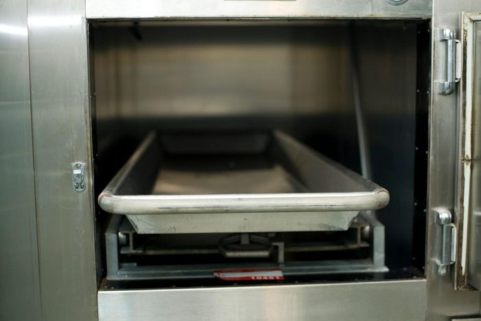 Open hospital morgue drawers used for the storage of human bodies awaiting identification or autopsy.