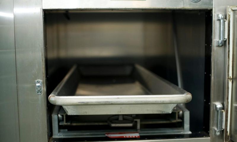 Open hospital morgue drawers used for the storage of human bodies awaiting identification or autopsy.