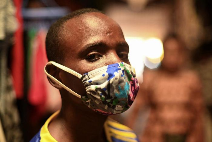 Eugene Amuri, a vendor at the Kimironko market wears a handmade "kitenge" cloth mask as he attempts to protect against the coronavirus disease (COVID-19), in Kigali, Rwanda March 17, 2020. (REUTERS/Maggie Andresen)