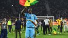 Edouard Mendy waves a Senegalese flag as he celebrates winning the Cup of Nations in Yaounde