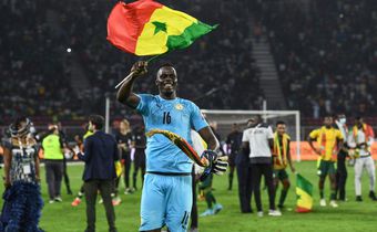 Edouard Mendy waves a Senegalese flag as he celebrates winning the Cup of Nations in Yaounde