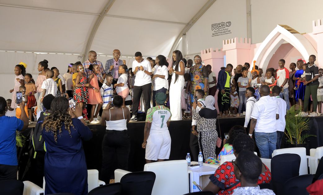 Children and exhibitors join the Minister in charge of Children and Youth Affairs Balaam Barugahara Ateenyi on stage during the Baby and Kids Expo 2024 at UMA Showgrounds.