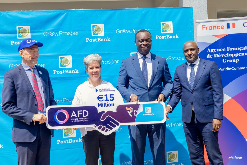 H.E. Virginie Leroy (C), Ambassador of France to Uganda, PostBank Uganda Managing Director Julius Kakeeto (L) Martin Mugisha, Executive Director, Operations (R), and Marc Trouyet, the Country Director for AFD in Uganda, during the announcement