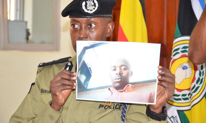 Police spokesperson Kituuma Rusoke displays the photo of Police Constable Charles Bahati in December (Photo courtesy: Nile Post)
