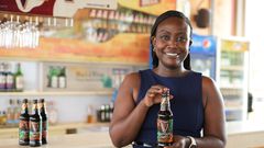 Elizabeth Mutamuliza, Marketing Manager - Beer Category showcasing the new Guinness Smooth bottle earlier today.