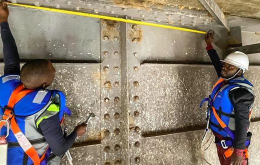 Engineers working underneath Karuma bridge