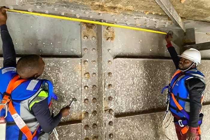 Engineers working underneath Karuma bridge