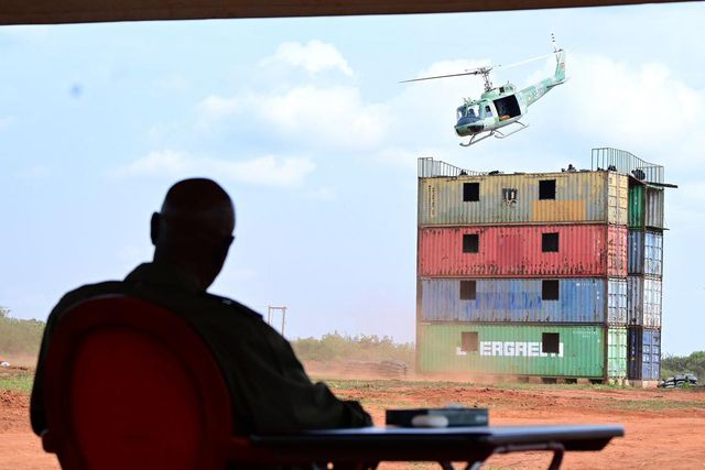 Museveni watches a chopper driill at the passing out event