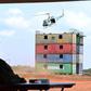 Museveni watches a chopper driill at the passing out event
