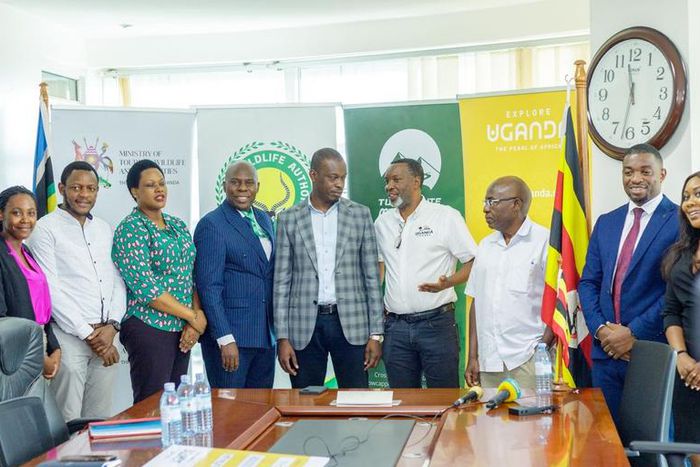Minister Martin Mugarra poses with the Rwenzori Marathon team along with officials from the Ministry and UWA