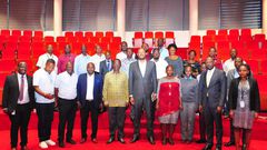 UIA Director General Robert Mukiza (4R) and Daudi Migereko (4L) with Kikuubo traders at UIA Head Office in Kampala