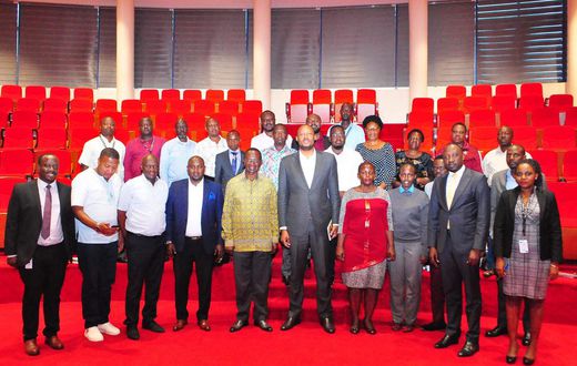UIA Director General Robert Mukiza (4R) and Daudi Migereko (4L) with Kikuubo traders at UIA Head Office in Kampala