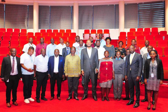 UIA Director General Robert Mukiza (4R) and Daudi Migereko (4L) with Kikuubo traders at UIA Head Office in Kampala