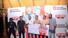 (L) Hillary Baguma- UBL Brand Manager Uganda Waragi and the Marketing Manager Spirirts-Robert Nsibirwa hand over dummy cheque to the first three Laga Swaga promo winners at the promotion launch