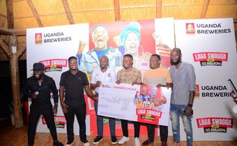 (L) Hillary Baguma- UBL Brand Manager Uganda Waragi and the Marketing Manager Spirirts-Robert Nsibirwa hand over dummy cheque to the first three Laga Swaga promo winners at the promotion launch