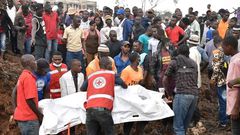 Red Cross first responders retrieve a body from the collapsed landfill