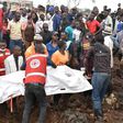 Red Cross first responders retrieve a body from the collapsed landfill