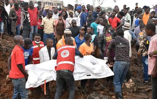 Red Cross first responders retrieve a body from the collapsed landfill