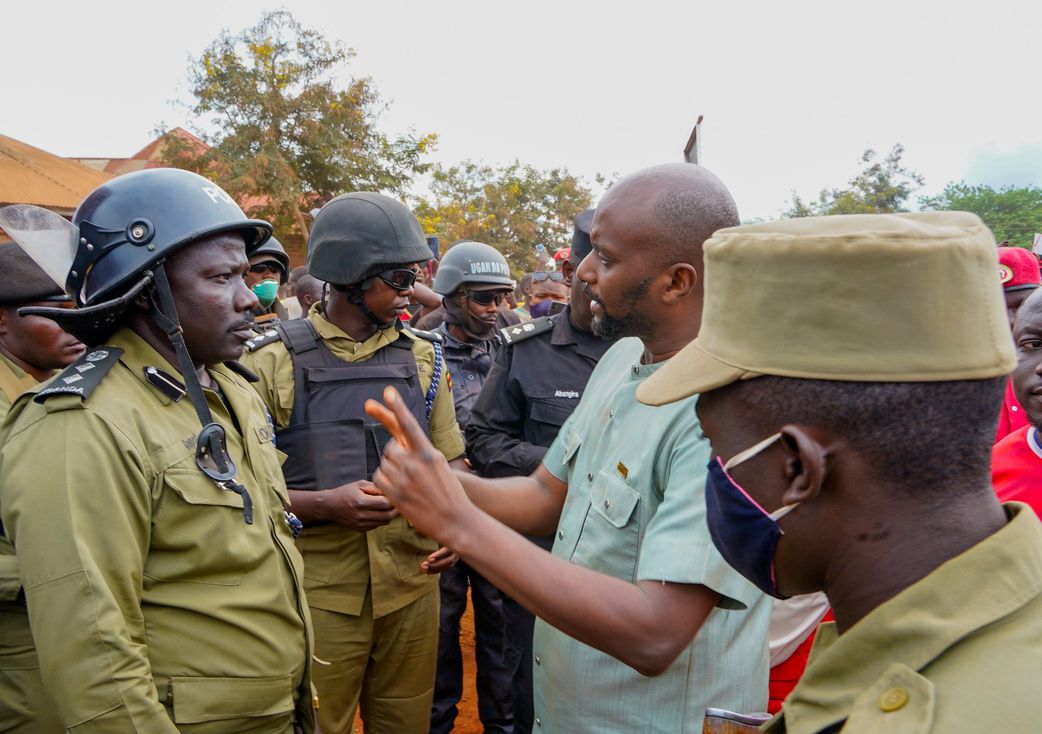 NUP SG David Lewis Rubongoya engages with security operatives at a roadblock