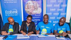 Ecobank Uganda Head of Commercial Banking, Elizabeth Mwerinde Kassedde and Moses Okiror, CEO SurePay signing the MEO at the launch of the partnership.