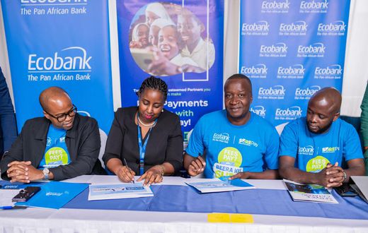 Ecobank Uganda Head of Commercial Banking, Elizabeth Mwerinde Kassedde and Moses Okiror, CEO SurePay signing the MEO at the launch of the partnership.
