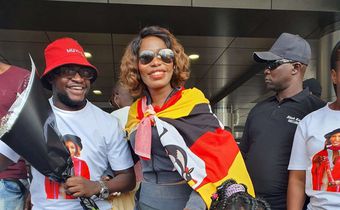 Ritah Kaggwa on arrival draped with Uganda flag