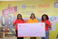 Coca Cola's Damalie Wasukira & Sheila Najjita hand over a dummy cheque to Bell Brand Manager Lillian Kansiime Ssebunya