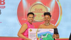 Jubilee Life Insurance COO Dorcus Kuhimbisa (L) awards Diana Ndege Ssempasa one of the top winners on the night